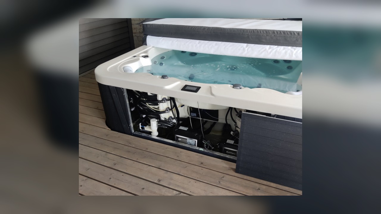 Real hot tub equipment bay with pumps, heater, and control equipment